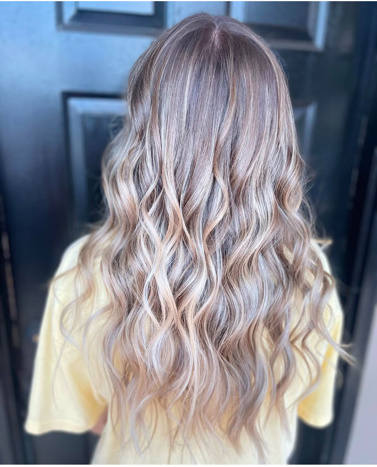 Long ash blonde balayage waves by Magnolias Hair Salon